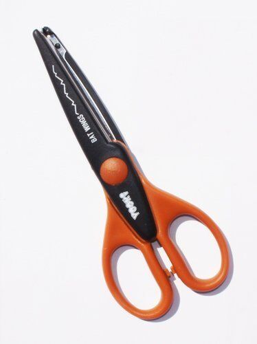 Creative paper edger scissors with bat wing edges on a white background.