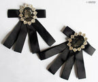 Two vintage brooches displayed together with clear crystals