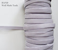 Icy white flat elastic cord spool, 12mm width, 140g.