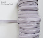 Spool of icy white extra strength max stretch flat elastic cord, 8mm wide.