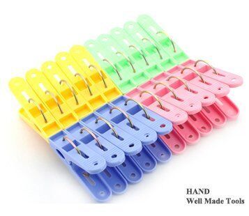 Close-up of a colourful plastic clothes peg showcasing its strong spring.