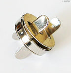 Assorted sizes of silver magnetic buttons in a neat arrangement