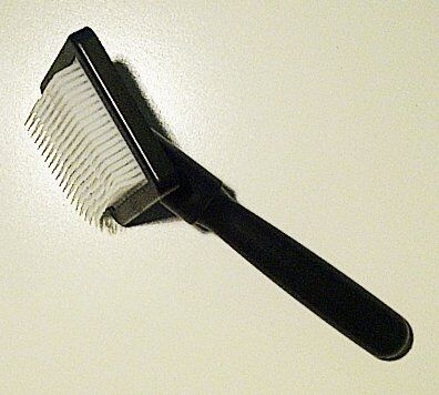 Fur care brush in use on a fabric surface