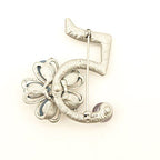 Close-up of diamante crystals and amber flower on brooch.