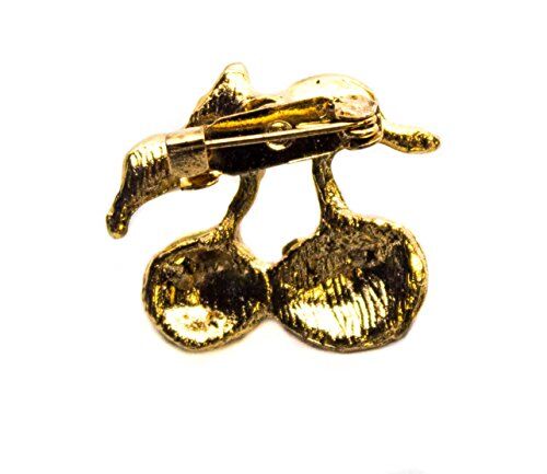 Close-up of the crystal and yellow enamel brooch with green leaves.