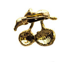 Close-up of the crystal and yellow enamel brooch with green leaves.