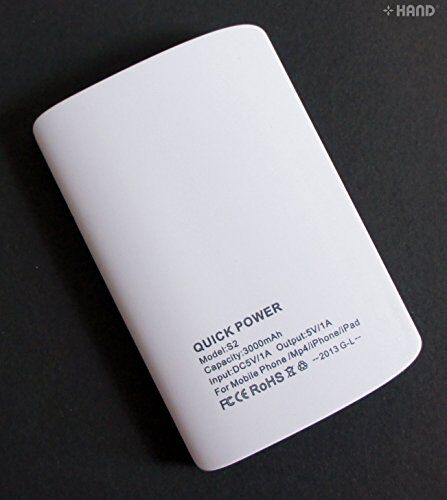User holding the portable charger while charging a smartphone