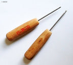 Large stitching awl with wooden handle for comfortable grip.