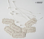 Close-up of the off-white paper tag showing the lock string.