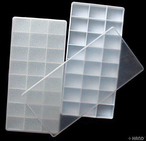 Open plastic palette showing 24 wells for paint