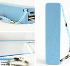 Portable battery charger held in hand for size reference.