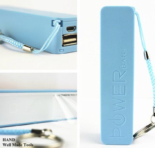 Portable battery charger held in hand for size reference.