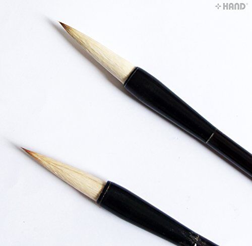Sumi brush in use for calligraphy on paper.