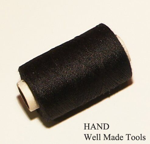Twelve spools of black polyester sewing thread arranged neatly.