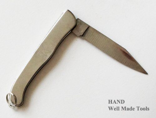Folding knife in hand, showcasing its compact size