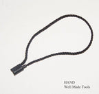 Close-up of a nylon string round snap lock hang tag