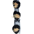 Close-up of black knitted decorative rosettes trim with beading.