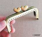 Side view of the antique bronze coin purse frame.