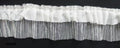 Close-up of black ruffle net trim showing texture and design