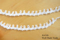 Nylon loop trim in white, ideal for garment decoration.