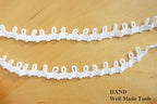 Nylon loop trim in white, ideal for garment decoration.