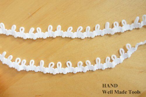 Nylon loop trim in white, ideal for garment decoration.