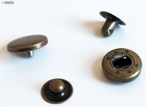 Close-up of vintage gold press stud button components