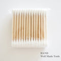 Three packs of double end wooden grip cotton swab buds in white.