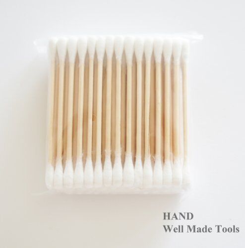 Three packs of double end wooden grip cotton swab buds in white.