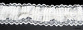 Roll of black elastic lace trim on a white background