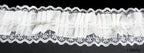 Roll of black elastic lace trim on a white background
