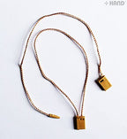 Caramel snap lock hang tags in a pack, ready for use in crafts.