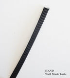 Cut piece of black boning used in garment construction