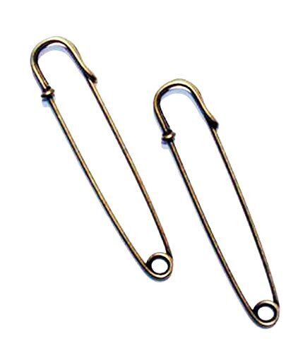 Close-up of a vintage gold kilt pin showing its detailed design.