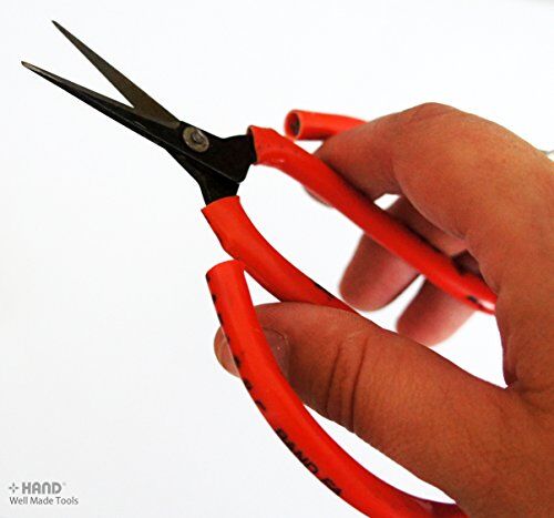 Scissors cutting through fabric, showcasing their precision and strength.