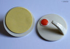 Self adhesive hooks in use, holding items in a bathroom setting.