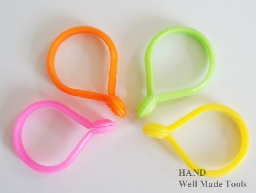 Close-up of a single orange plastic curtain ring measuring 32mm.