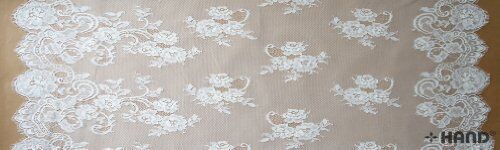 Fine vintage cream wide corded lace displayed on a table