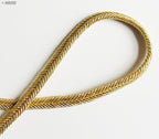Close-up of gold metallic plait cord texture.