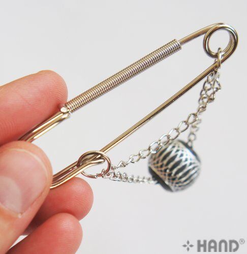 Textured bead detail on a silver kilt pin with chain