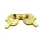 Close-up of a John Lennon dark sunglasses design brooch showing black enamel detail.