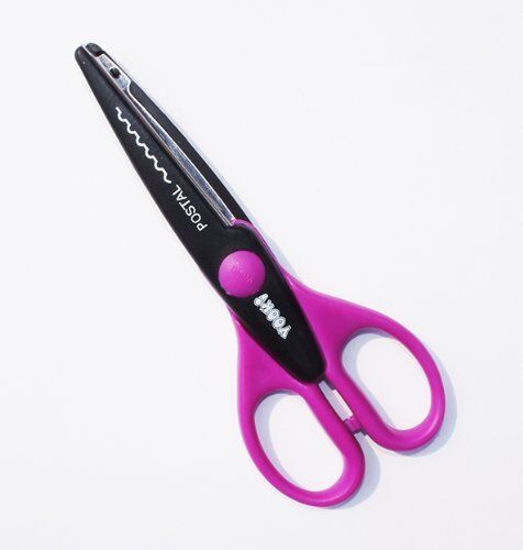 Serrated paper edger scissors displayed on a crafting table