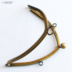 Purse frame showing eyelets for shoulder strap attachment.