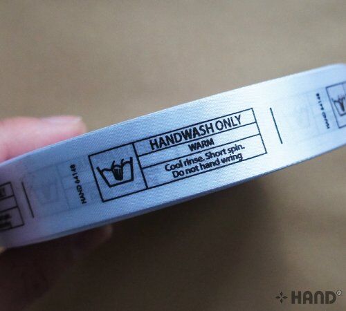 Two rolls of wash care labels ready for use in sewing projects.