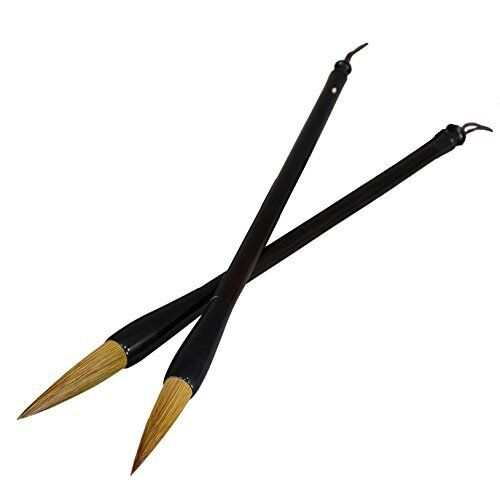 Sumi brushes resting on a textured paper background.