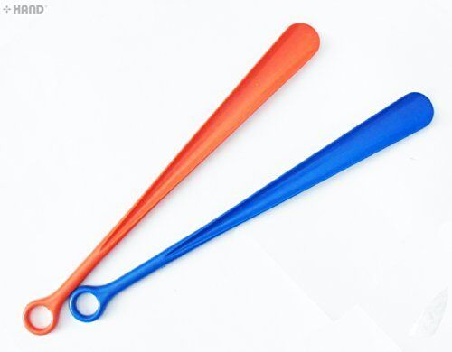 A close-up of a plastic shoehorn showing its sturdy design.