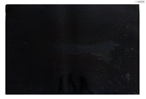Black flexible rubber cutting mat on a work surface