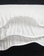 Black nylon frill ruffle elastic trim displayed with sewing tools.