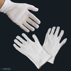 Close-up of a white cotton glove showing its stretchable fabric
