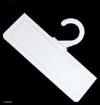 White plastic hangers hanging fabric samples neatly.